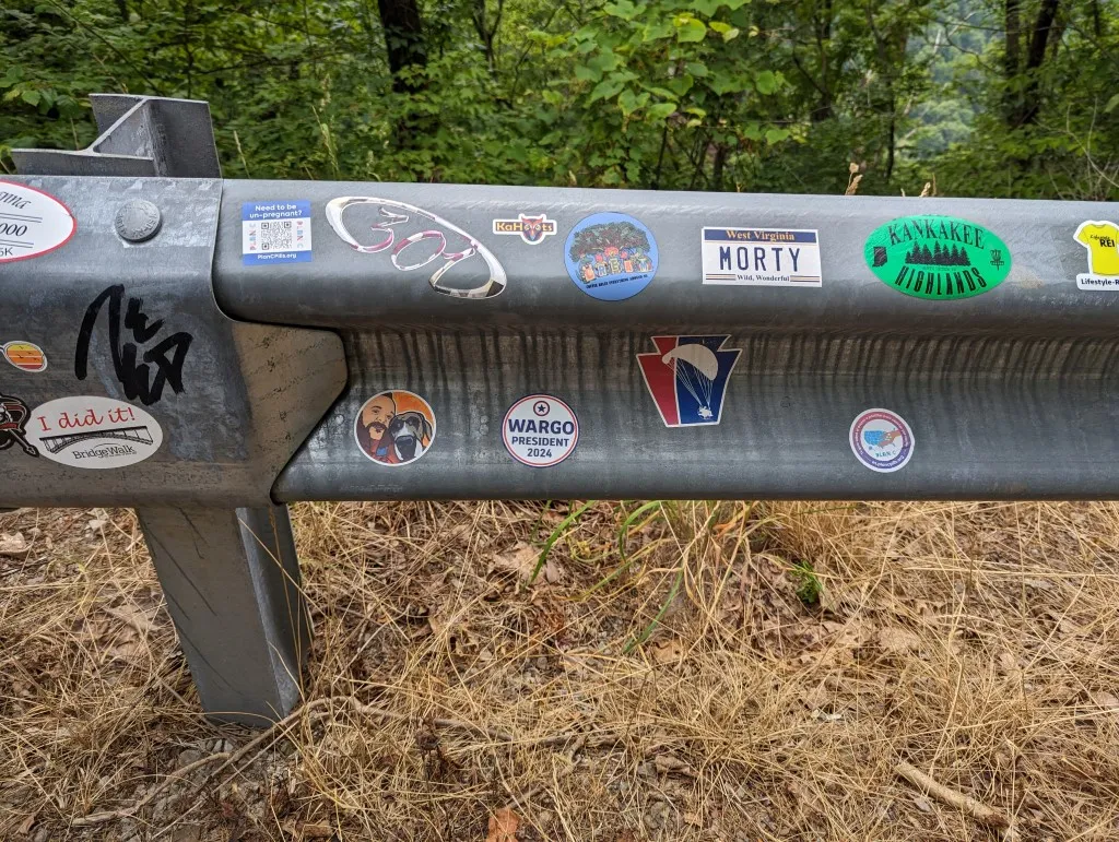 An image of a road guardrail with a Wargo 2024 sticker on it.